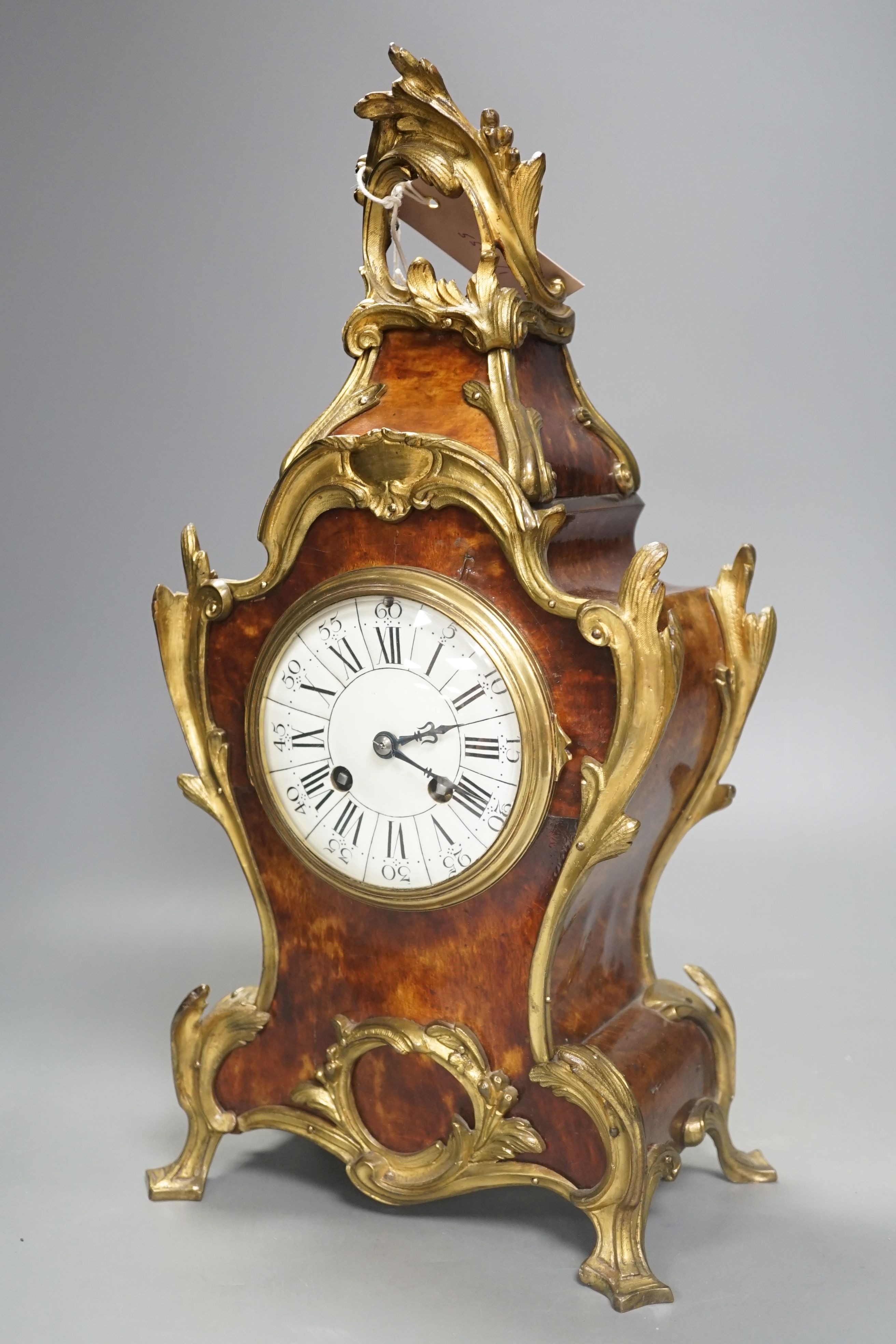 A 19th century French tortoiseshell and ormolu mounted mantel clock, 40 cms high.